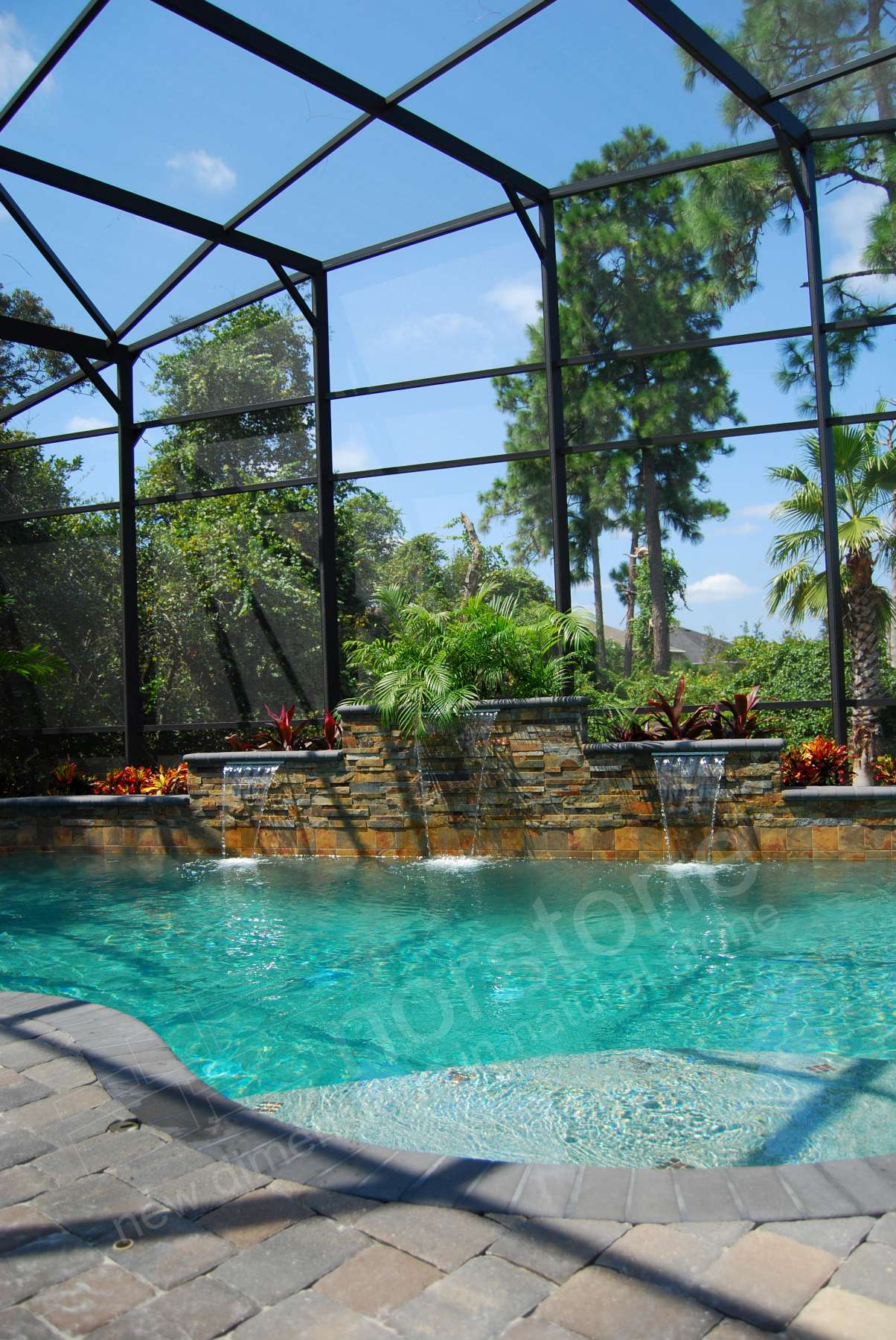 Norstone Ochre XL Stacked Stone Panels used on a pool raised beam with extensive landscaping